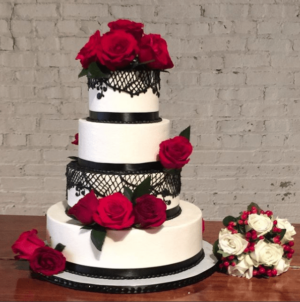 A three-tiered Quinceanera cake with red roses