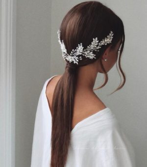 Quinceanera hairstyle, a woman with long hair wearing a white top