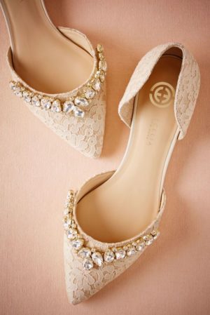 A pair of Quinceanera sandals with pearls on them