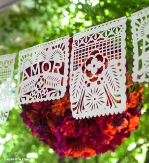 Printable Quinceanera papel picado templates PDF. Papel picado, a bunch of paper decorations hanging from a tree.