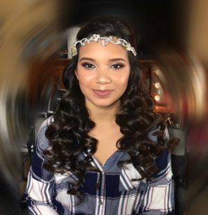 A woman with long hair wearing a Quinceanera headpiece and a headband