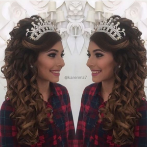 A woman with long hair wearing a Quinceañera headpiece.