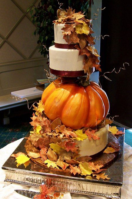 A Quinceanera cake, shaped like a pumpkin and decorated with pumpkins and leaves on top.