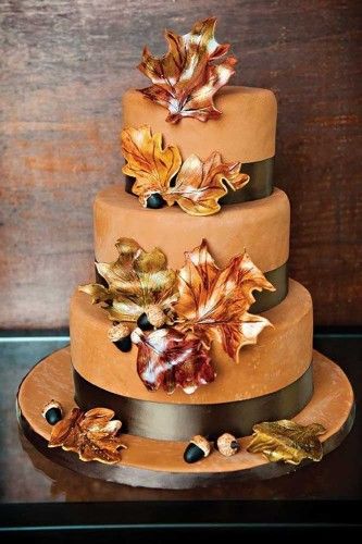 Quinceanera cake, a three-tiered cake decorated with flowers and leaves, with an autumn theme.