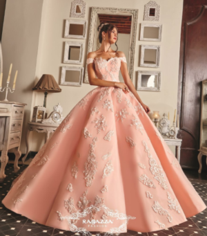 Quinceanera gown ideas: A woman in a pink dress standing in a room for her 18th birthday