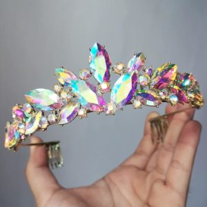 A person wearing a Quinceanera headpiece Tiara and holding a colorful crystal hair comb