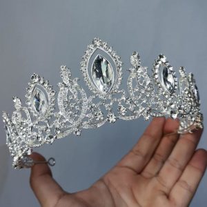 A woman holding a Quinceanera tiara