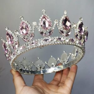 A hand holding a Quinceanera MINI jewellery, decorated with pink and white crystals