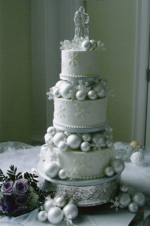 Quinceanera cake, a white cake with ornaments on top in a winter wonderland theme