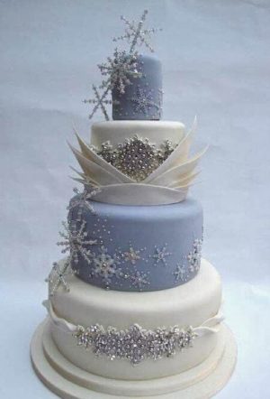 Quinceanera cake, a three tiered cake with snowflakes on top, inspired by the Frozen theme
