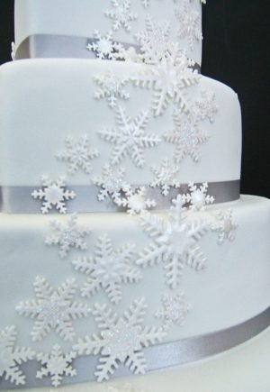 Quinceanera cake, a white quinceanera cake with snowflakes on it