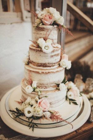A Quinceanera cake, a three-tiered cake with flowers on top