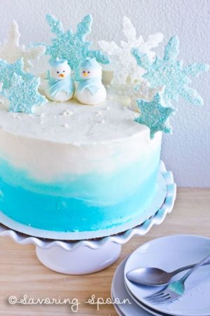 Quinceanera winter wonderland cake design Cupcake, a blue and white cake with snowflakes on top