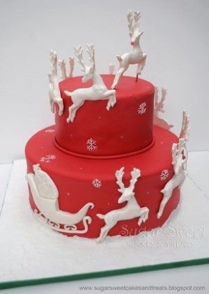 Quinceanera cake featuring a festive reindeer design with reindeers and sleigh on top, perfect for celebrating a special occasion