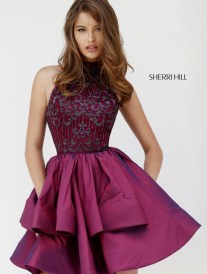 A fashion model wearing a T-shirt and a woman in a purple dress posing for a picture at a Quinceanera