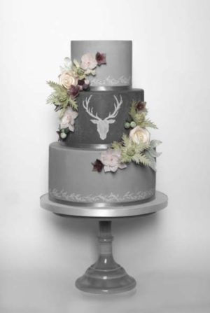 Quinceanera cake, a three tiered cake decorated with flowers and a deer head