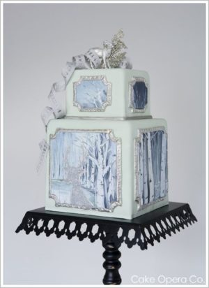 An elegant Quinceanera cake featuring a three-tiered Torte cake on a black stand