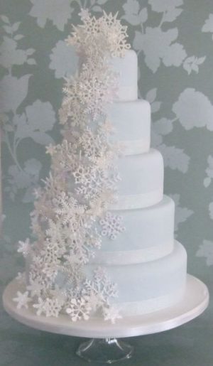 A Quinceanera cake, a white winter wonderland cake with snowflakes on top