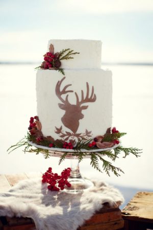 A Quinceanera cake, with a deer head on top, decorated for the celebration