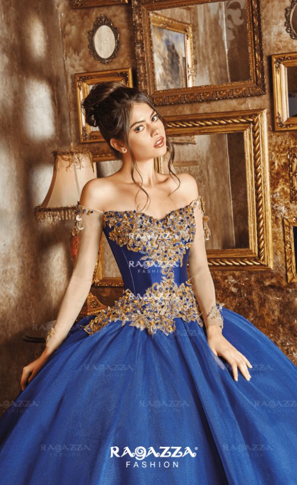 A woman in a blue gown posing for a picture at a Quinceanera event