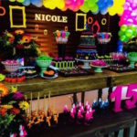 A festive Quinceanera party in the style of the 1980s, featuring a table adorned with colorful balloons