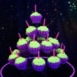 A Quinceanera glow party with a cupcake tower and candles on top