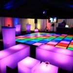 A neon quinceanera party with a room filled with lots of different colored lights