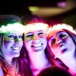 A group of young women standing next to each other at a Quinceanera party.