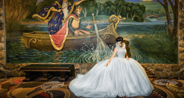 Quinceanera Art: A woman in a Quinceanera dress standing in front of a painting