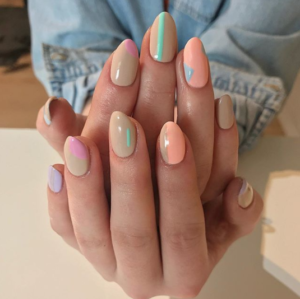 A person holding a pair of manicured Quinceanera nails