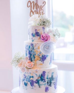 Quinceanera cake: a three-tiered cake with flowers and a Quinceanera topper