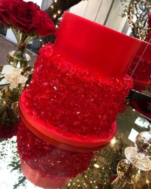A Quinceanera-themed Christmas ornament sitting on top of a glass table