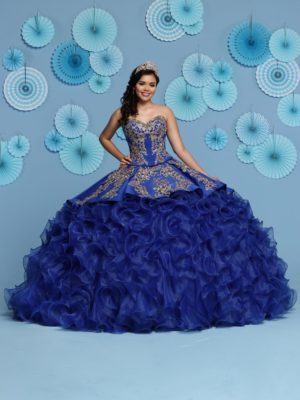 A woman in a blue dress posing for a picture in davinci quinceanera dresses