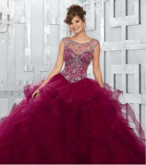 A woman in a red Quinceanera dress posing for a picture