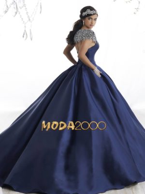 A woman posing for the camera in a blue ball gown Quinceañera dress