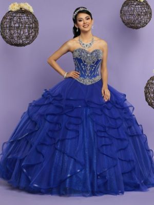 A woman in a blue Quinceañera dress posing for a picture.