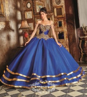A woman in a blue Quinceañera dress standing in a room