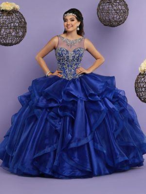 A woman in a blue quinceañera dress posing for a picture.