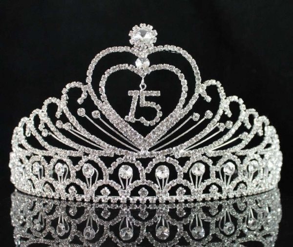 A Quinceanera tiara with a heart-shaped initial on it
