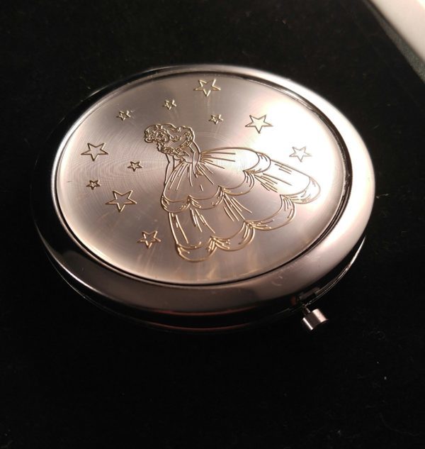 A Quinceanera themed compact mirror with a picture of a fairy, available on Amazon.com as a Quinceanera souvenir
