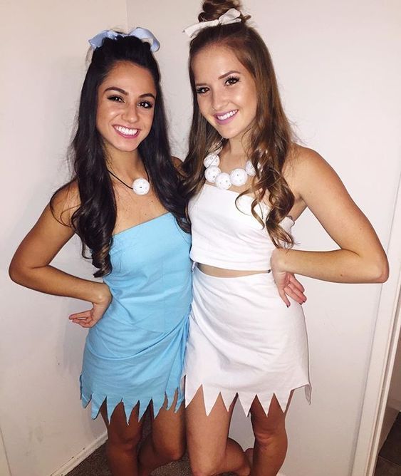 Two best friends dressed in cute Halloween costumes for Quinceanera, standing next to each other