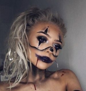 A woman wearing a Halloween costume with makeup, including a star on her face, for a Quinceanera.