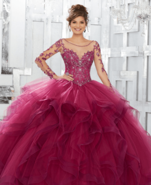 A woman in a red dress posing for a picture in the quinceañera dresses with sleeves
