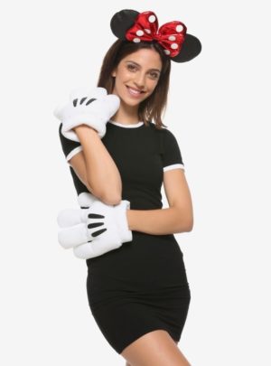 A woman in a black dress and Minnie Mouse ears wearing a shoulder T-shirt at a Quinceanera