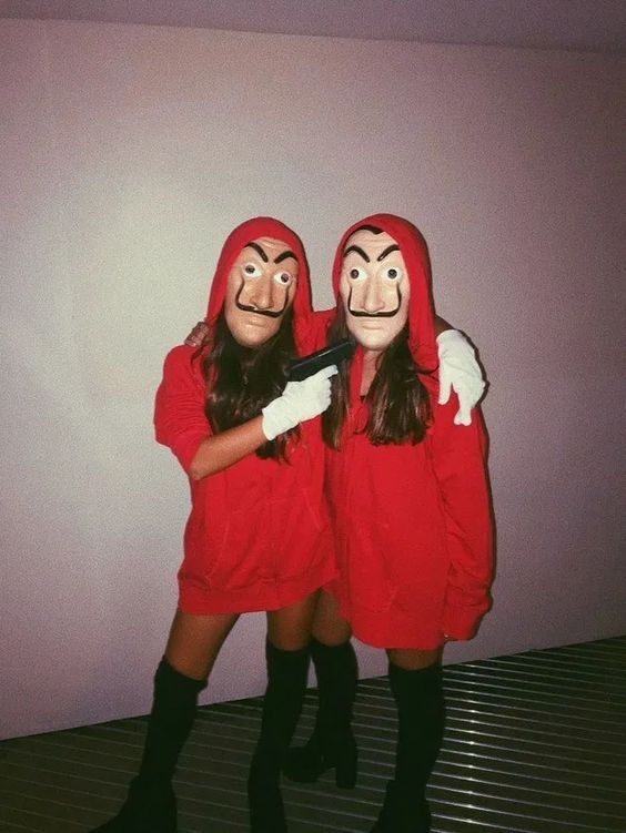 Two women dressed in red posing for a picture in a Quinceanera Halloween costume