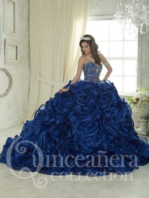 Quinceañera dress 26834: A woman in a blue dress standing in a room