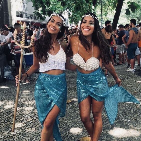 Two women dressed in blue skirts and white bra tops, Quinceanera costume ideas