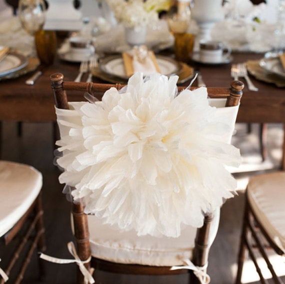 A wooden chair with a white flower centrepiece