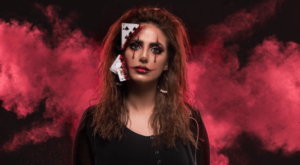 A girl with quinceanera hair, a woman with blood on her face holding a cell phone to her ear