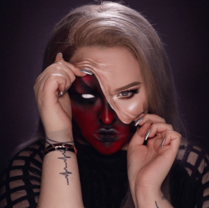 Nikkie de Jager wearing black and red face paint for a Quinceanera celebration
